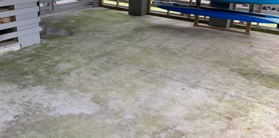 Concrete patio with mildew before pressure washing