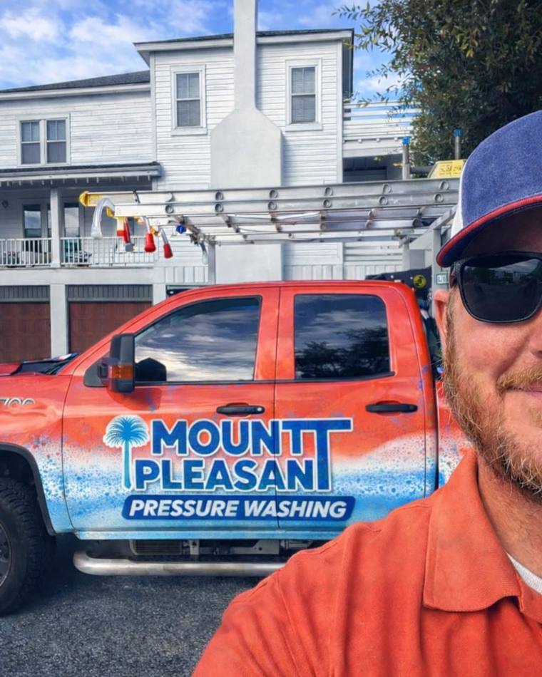 Owner of Mount Pleasant Pressure Washing with the company truck at a client home